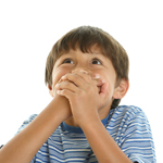Young playful boy covering mouth